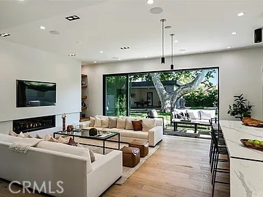 12132 Otsego Street Valley Village, CA 91607 - Photo 74 of 75 a living room with furniture a flat screen tv and floor to ceiling window