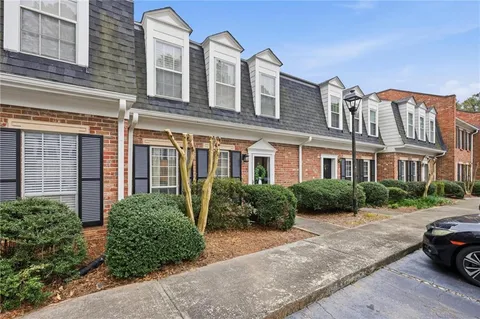 a front view of a residential apartment building with a yard