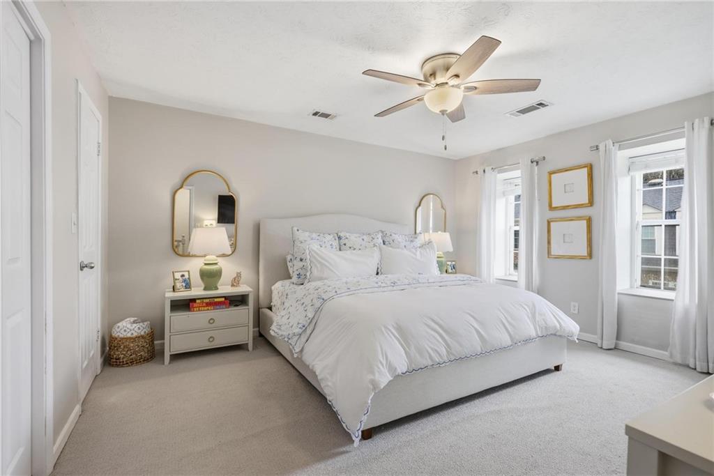 24 Independence Place Northwest Atlanta, GA 30318 - Photo 14 of 28 a bedroom with bed and window with ceiling fan