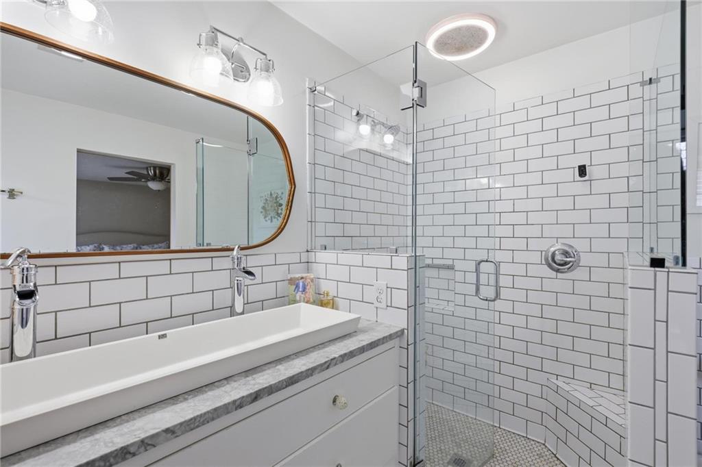 24 Independence Place Northwest Atlanta, GA 30318 - Photo 18 of 28 a bathroom with a sink a large mirror and a shower