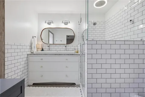 a bathroom with a sink mirror and vanity