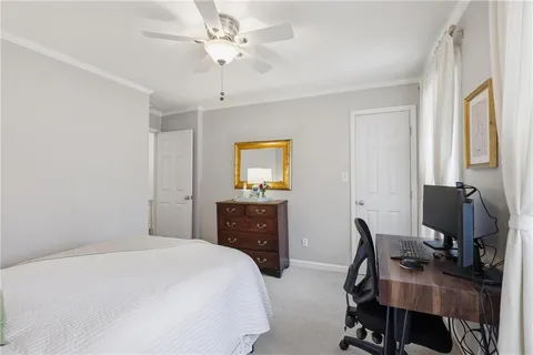 a bedroom with a bed and a desk