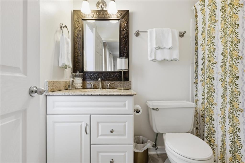 24 Independence Place Northwest Atlanta, GA 30318 - Photo 23 of 28 a bathroom with a granite countertop toilet sink and mirror