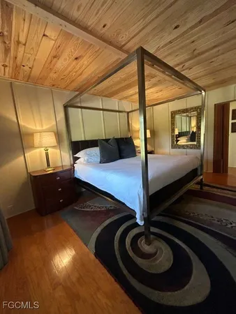 a bedroom with bed and balcony