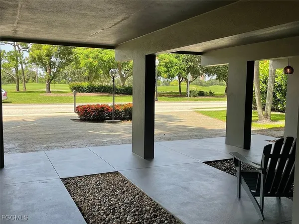 a view of a porch with furniture and garden