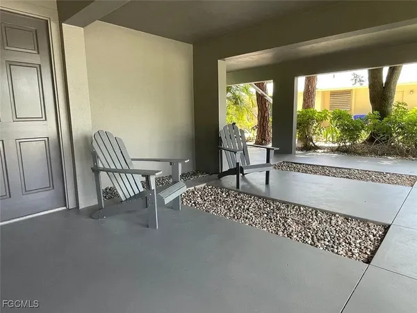a view of a porch with chairs and backyard