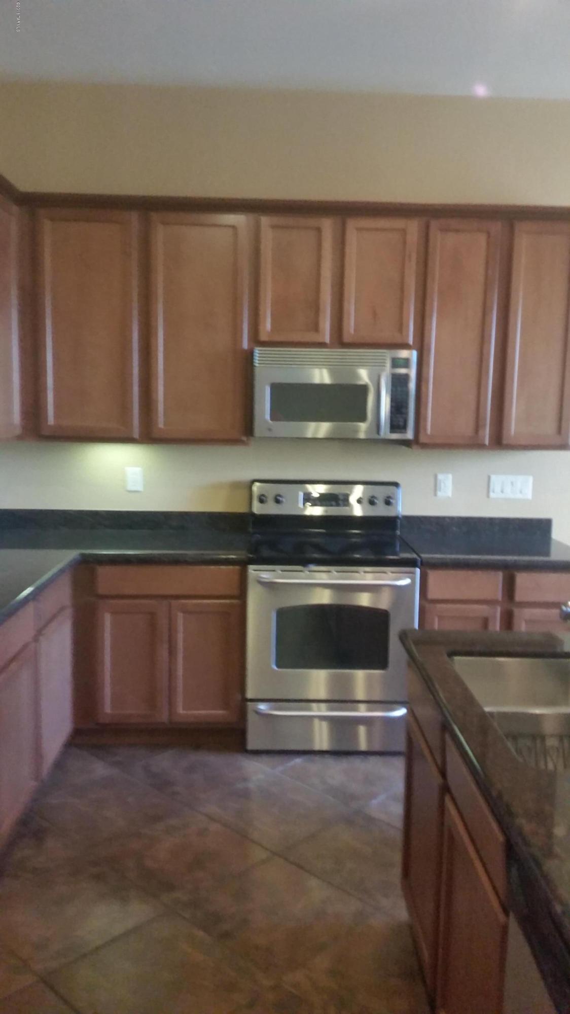 478 East Cedarvale Road Tucson, AZ 85704 - Photo 6 of 39 a kitchen with a stove and a sink