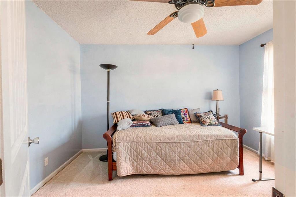 1606 Withers Way Krum, TX 76249 - Photo 18 of 35 a bedroom with a bed and a chandelier