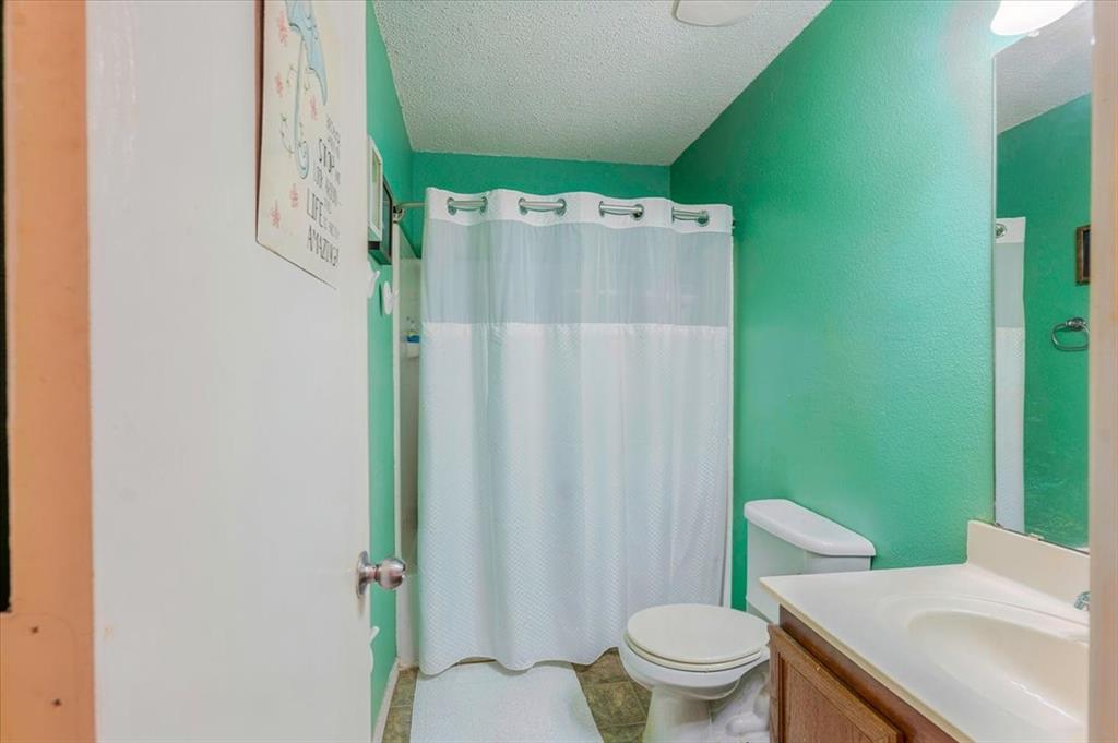 1606 Withers Way Krum, TX 76249 - Photo 20 of 35 a bathroom with a sink toilet and shower