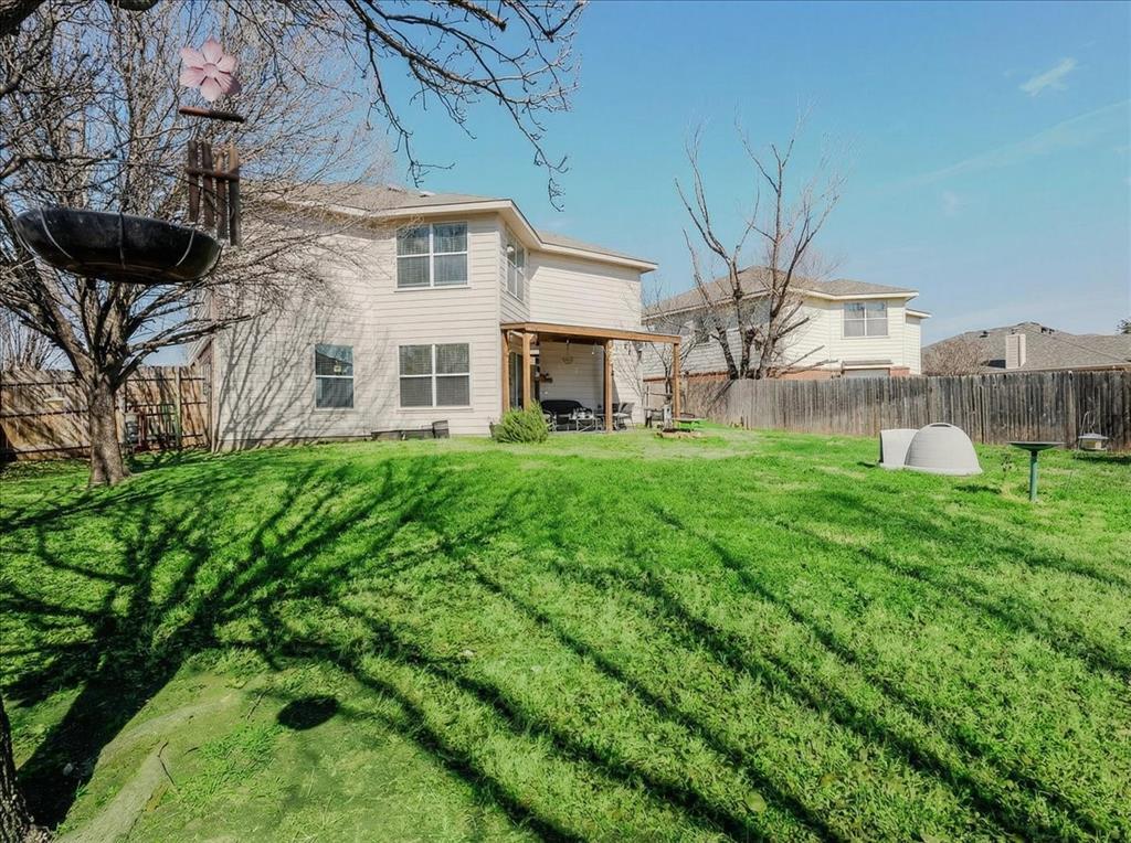 1606 Withers Way Krum, TX 76249 - Photo 24 of 35 a large brick building with a yard in front of it