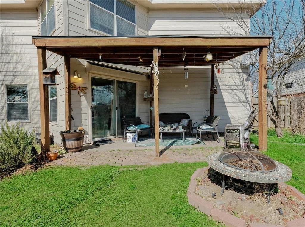 1606 Withers Way Krum, TX 76249 - Photo 25 of 35 a view of a backyard with table and chairs potted plants and a wooden bench