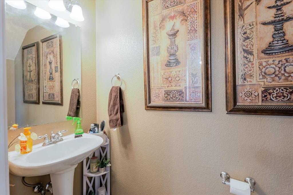 1606 Withers Way Krum, TX 76249 - Photo 26 of 35 a view of a bathroom with a sink and a mirror