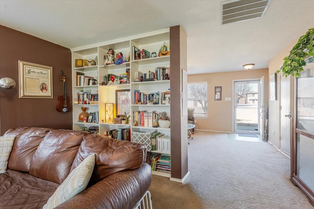 1606 Withers Way Krum, TX 76249 - Photo 30 of 35 a bed room with a bed and a book shelf