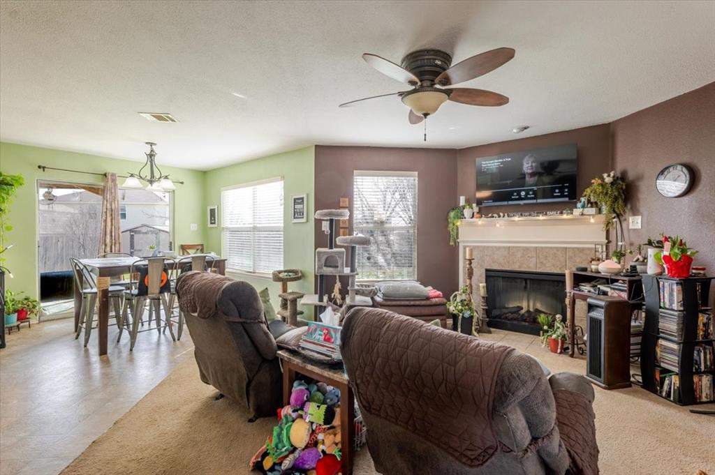 1606 Withers Way Krum, TX 76249 - Photo 31 of 35 a living room with furniture and a fireplace