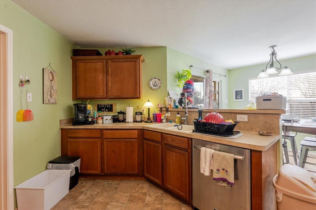 1606 Withers Way Krum, TX 76249 - Photo 35 of 35 a kitchen that has a sink and a stove in it