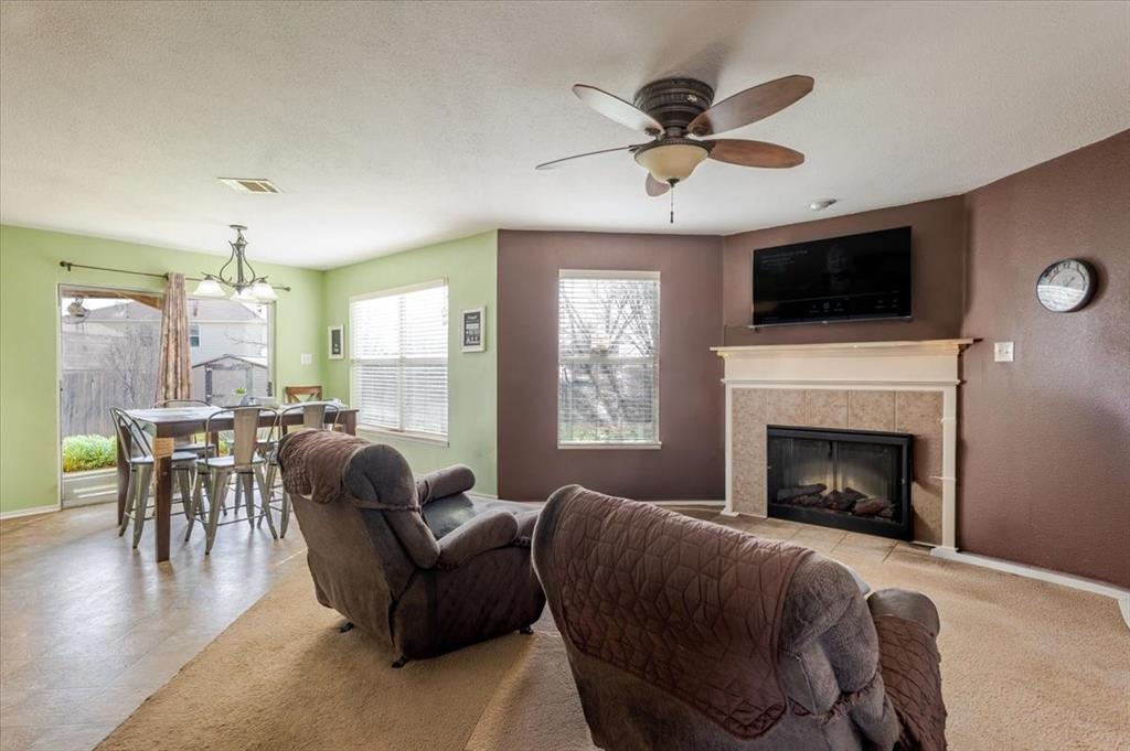 1606 Withers Way Krum, TX 76249 - Photo 5 of 35 a living room with furniture fireplace and a flat screen tv