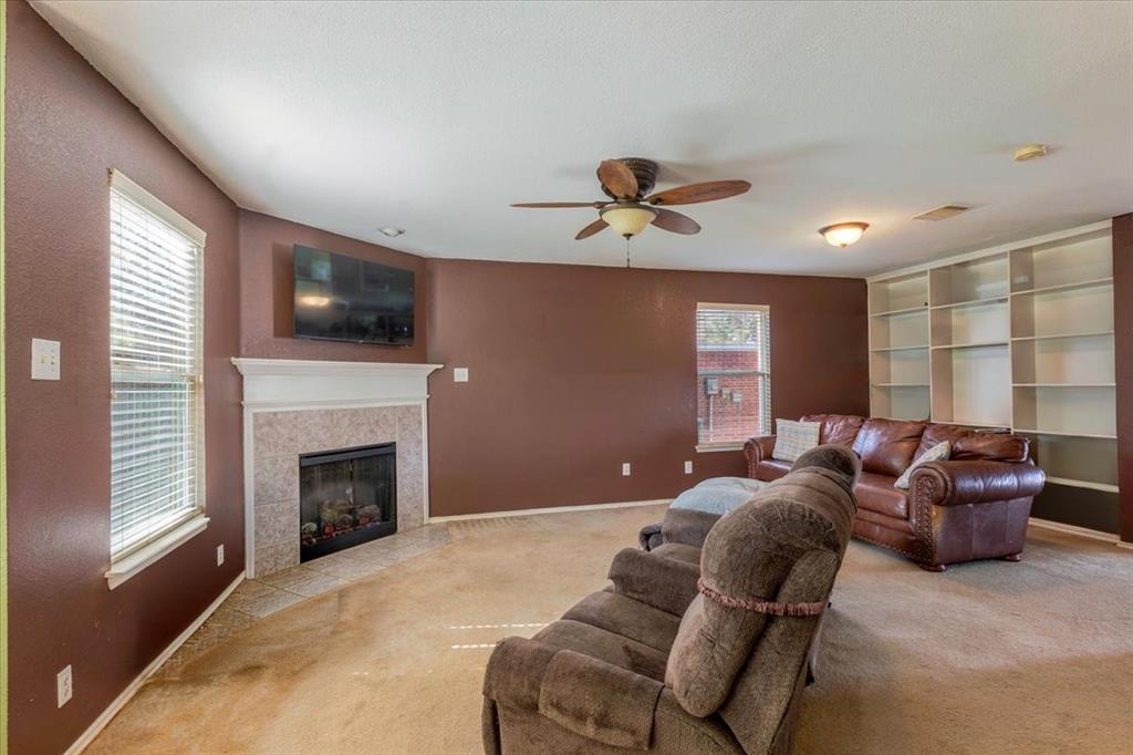 1606 Withers Way Krum, TX 76249 - Photo 6 of 35 a living room with furniture a flat screen tv and a fireplace