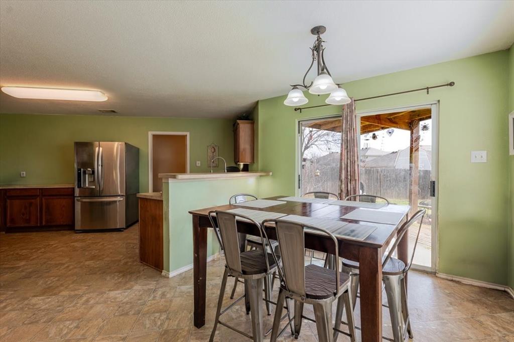 1606 Withers Way Krum, TX 76249 - Photo 8 of 35 a dining room with furniture a chandelier and window