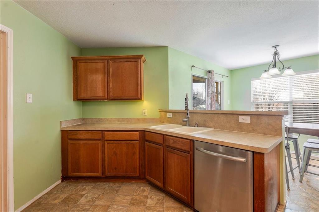 1606 Withers Way Krum, TX 76249 - Photo 10 of 35 a kitchen with a sink and cabinets