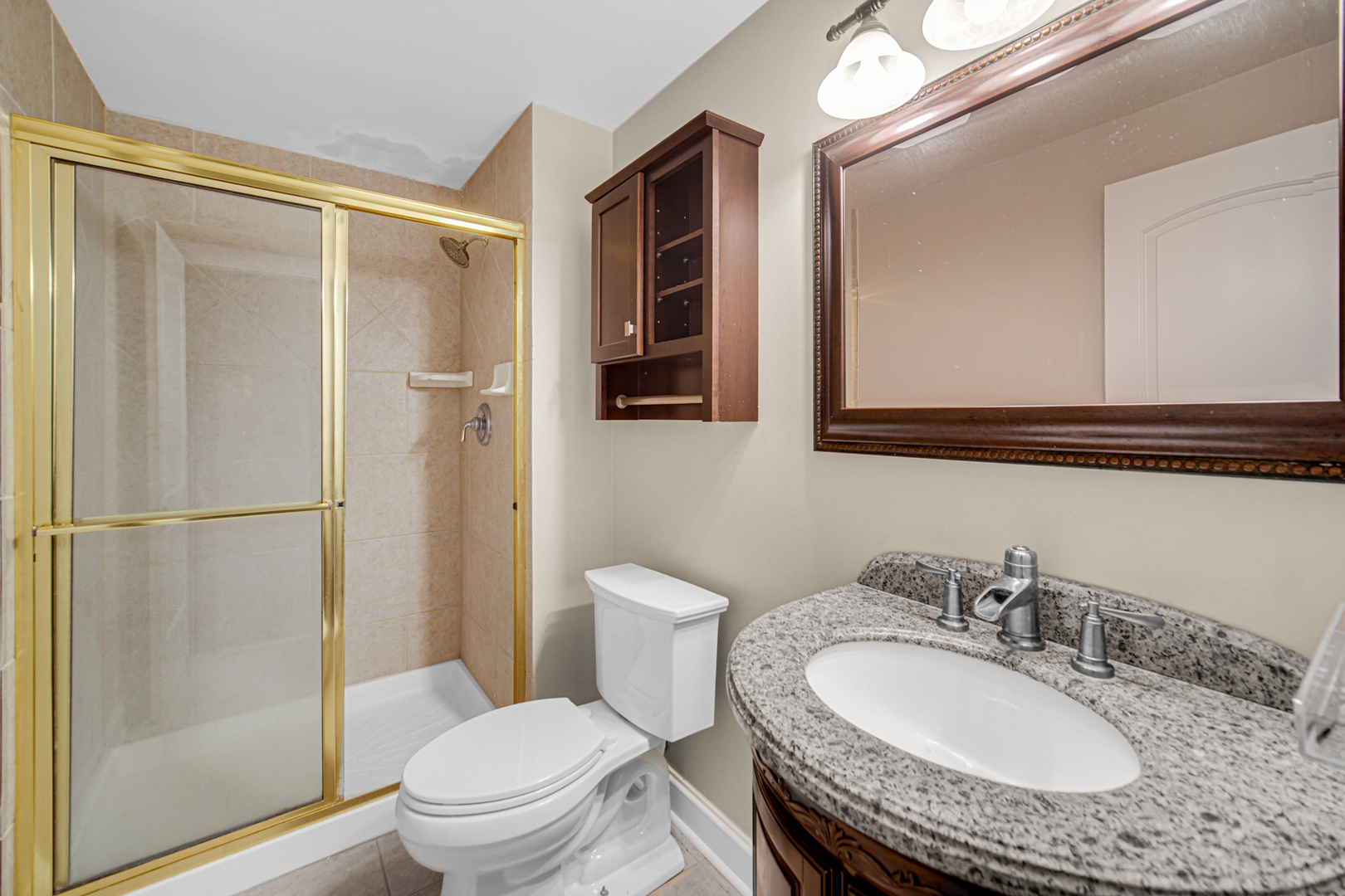 3N777 Walt Whitman Road St. Charles, IL 60175 - Photo 21 of 29 a bathroom with a granite countertop sink toilet a mirror a vanity and shower