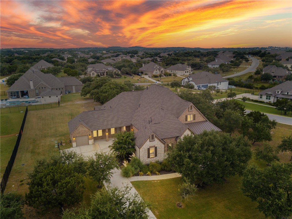 an aerial view of residential houses with outdoor space and ocean view