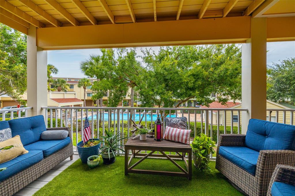 533 Sandy Hook Road Treasure Island, FL 33706 - Photo 11 of 46 a balcony with furniture and a garden