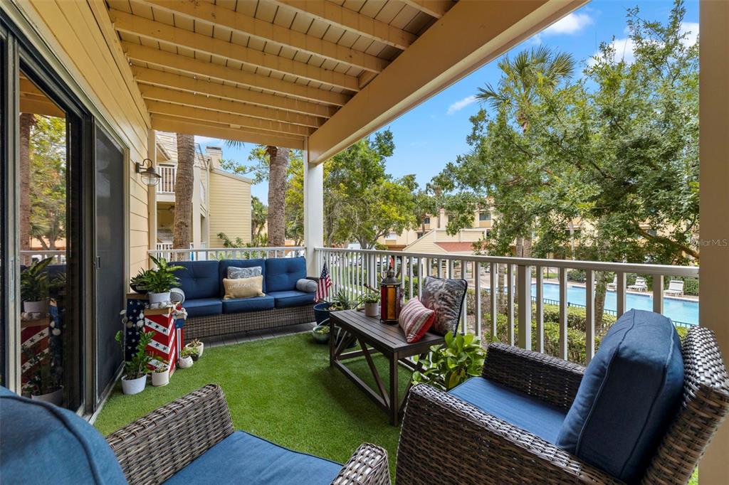 533 Sandy Hook Road Treasure Island, FL 33706 - Photo 12 of 46 a balcony with wooden floor and outdoor seating