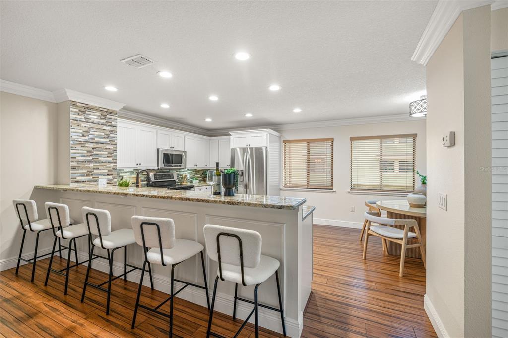 533 Sandy Hook Road Treasure Island, FL 33706 - Photo 14 of 46 a large kitchen with a table and chairs in it