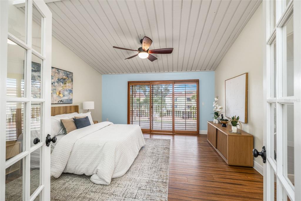 533 Sandy Hook Road Treasure Island, FL 33706 - Photo 19 of 46 a spacious bedroom with a bed and wooden floor