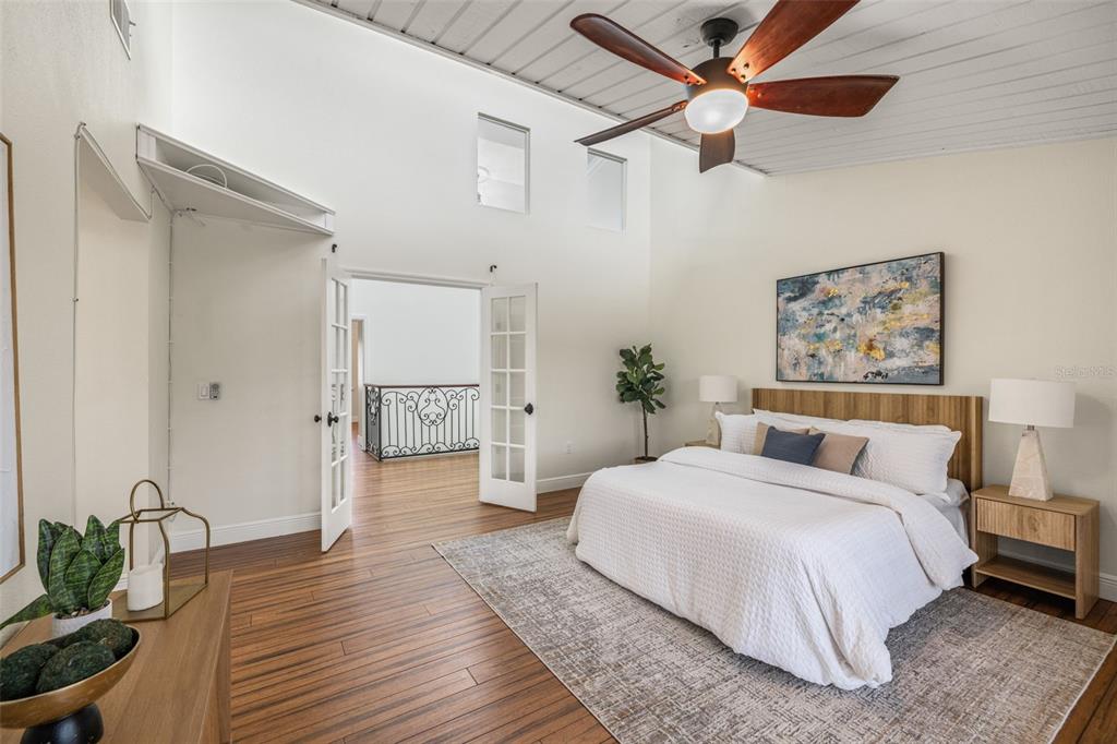 533 Sandy Hook Road Treasure Island, FL 33706 - Photo 21 of 46 a spacious bedroom with a bed and a chandelier
