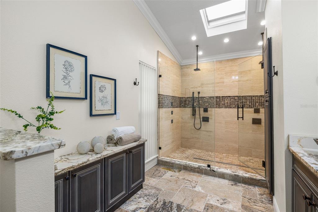 533 Sandy Hook Road Treasure Island, FL 33706 - Photo 23 of 46 a bathroom with a granite countertop sink a toilet and shower