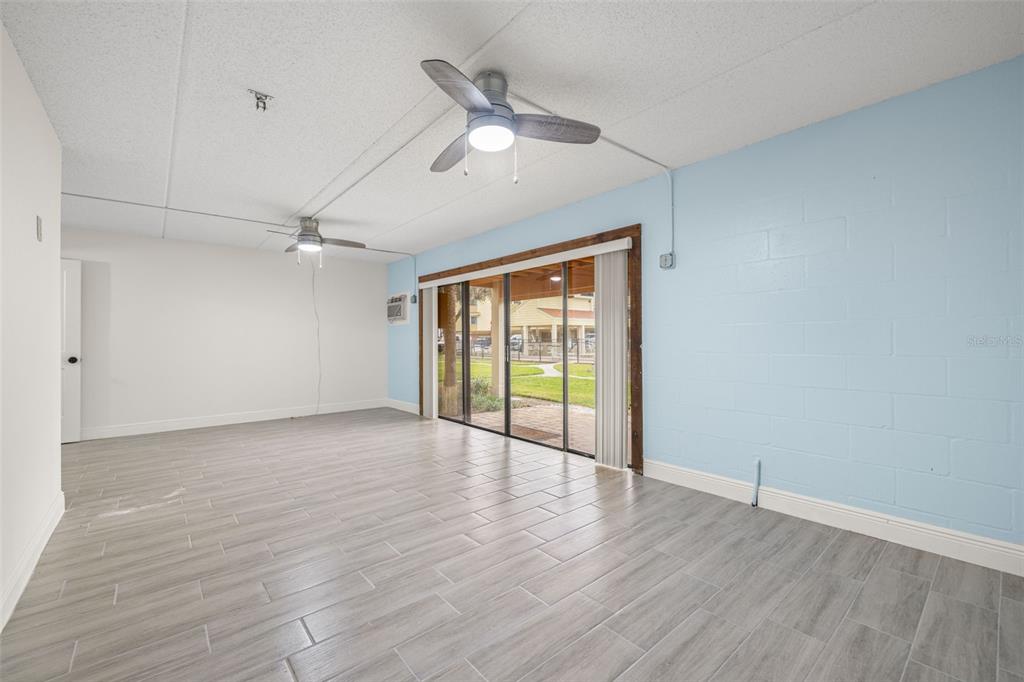 533 Sandy Hook Road Treasure Island, FL 33706 - Photo 30 of 46 an empty room with wooden floor fan and windows