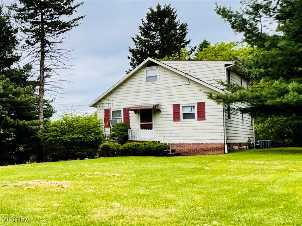 25911 Tryon Road Bedford, OH 44146 - Photo 35 of 49 View of front of home with a front lawn and central AC