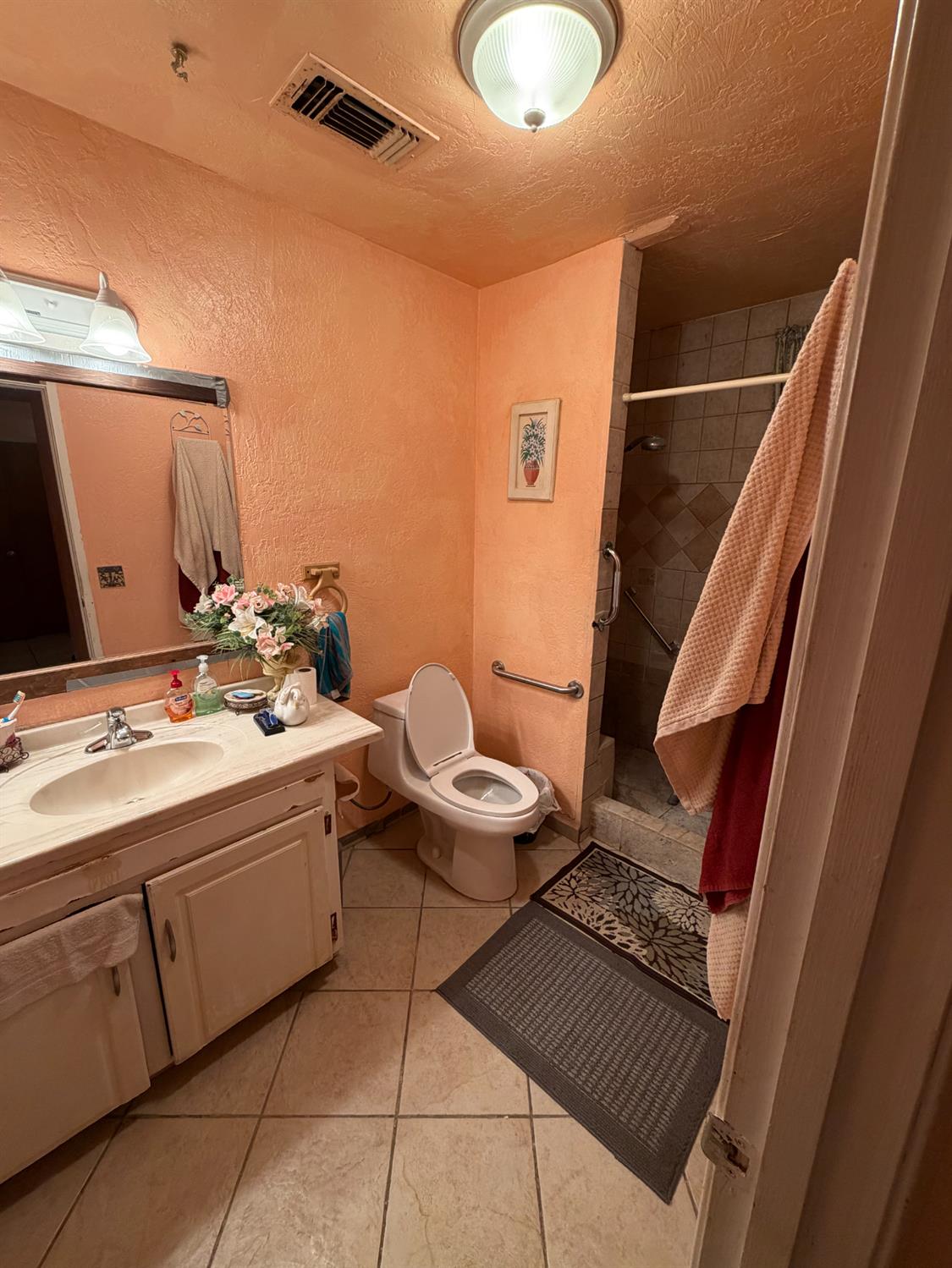 8767 South Rodriguez Avenue Parlier, CA 93648 - Photo 15 of 18 a bathroom with a sink mirror and toilet