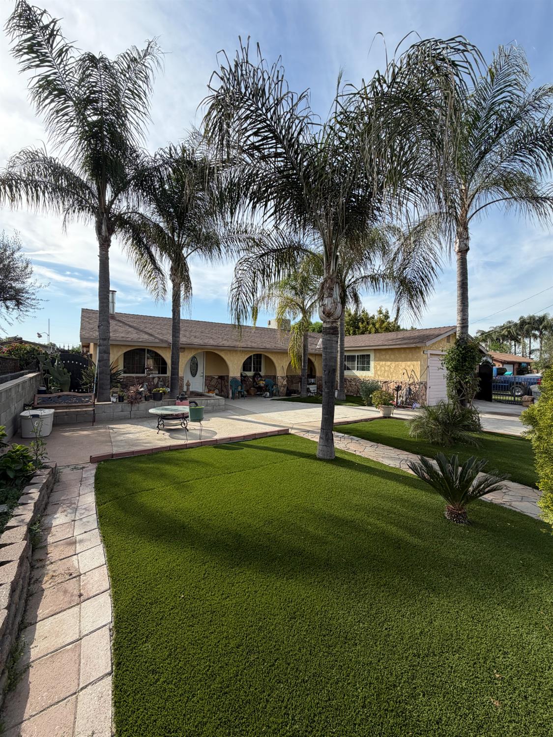 8767 South Rodriguez Avenue Parlier, CA 93648 - Photo 2 of 18 a swimming pool with outdoor seating and yard