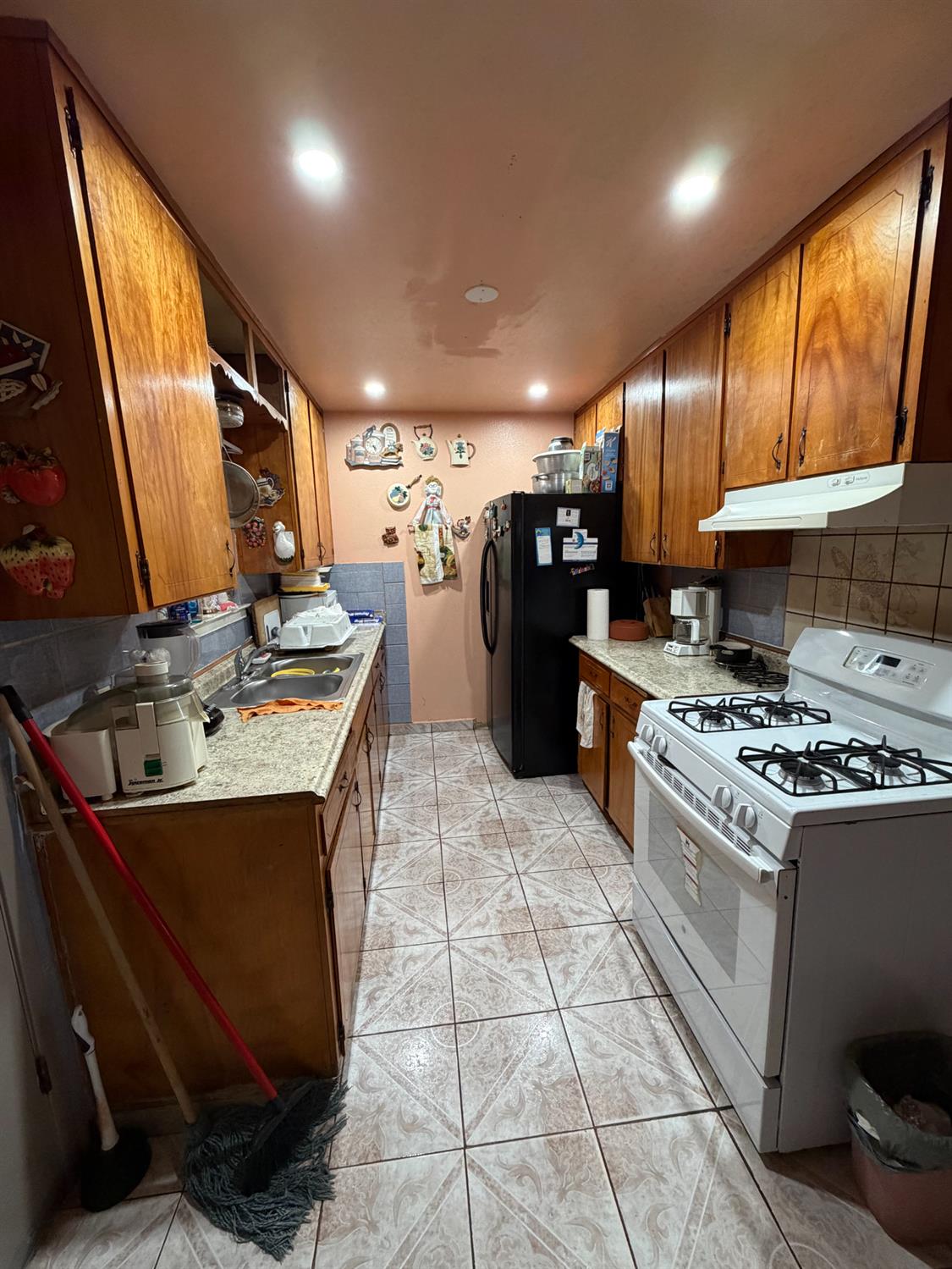 8767 South Rodriguez Avenue Parlier, CA 93648 - Photo 6 of 18 a kitchen with stainless steel appliances granite countertop a sink stove and refrigerator