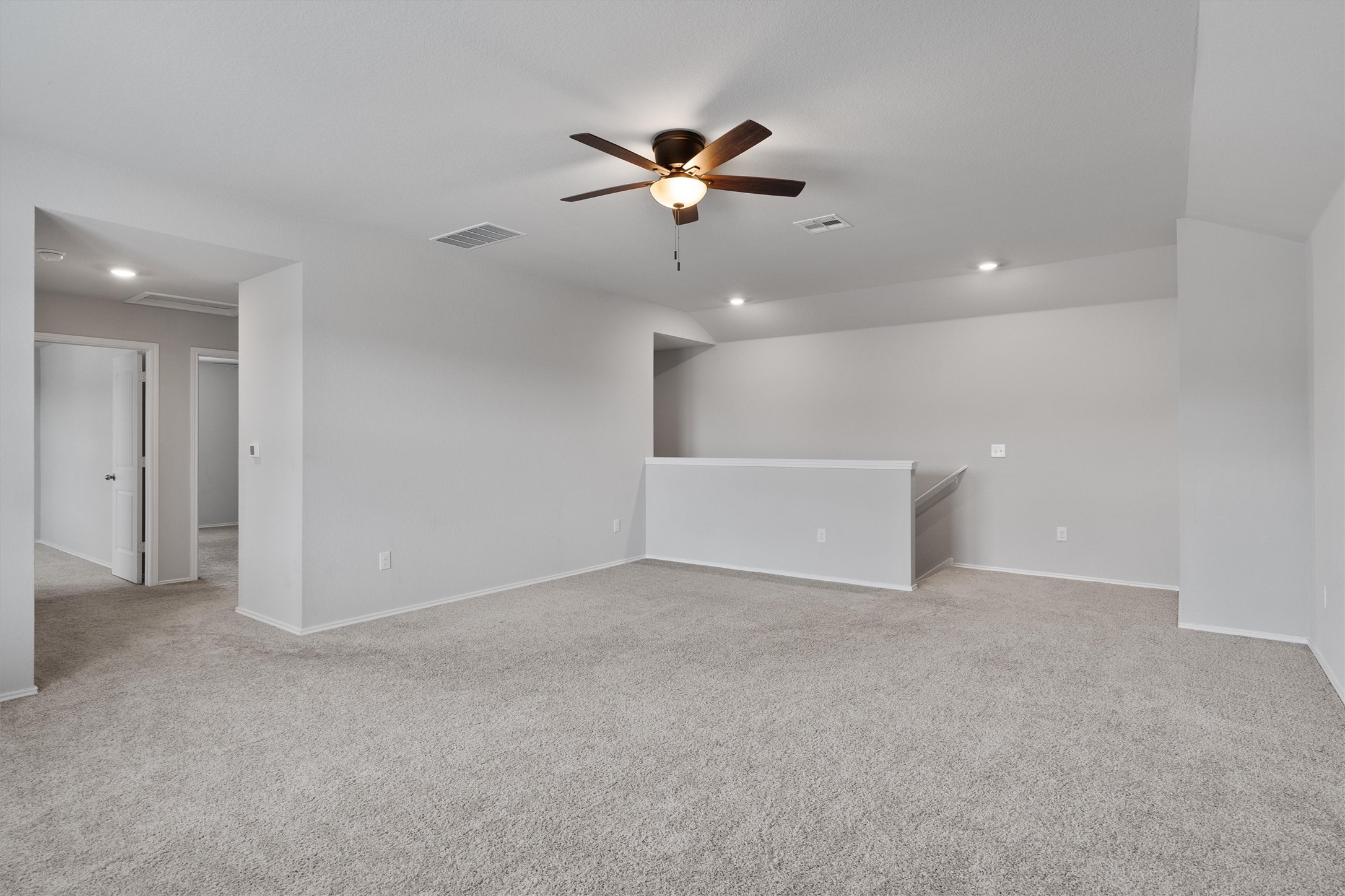 6121 Ronee Leah Drive Austin, TX 78724 - Photo 19 of 30 A spacious, naturally illuminated living area featuring plush carpeting and a modern ceiling fan.