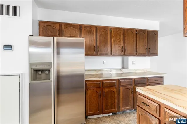 a kitchen with a refrigerator and cabinets