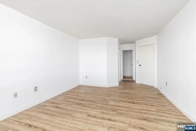 a view of a room with wooden floor