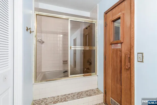 a bathroom with a glass shower door