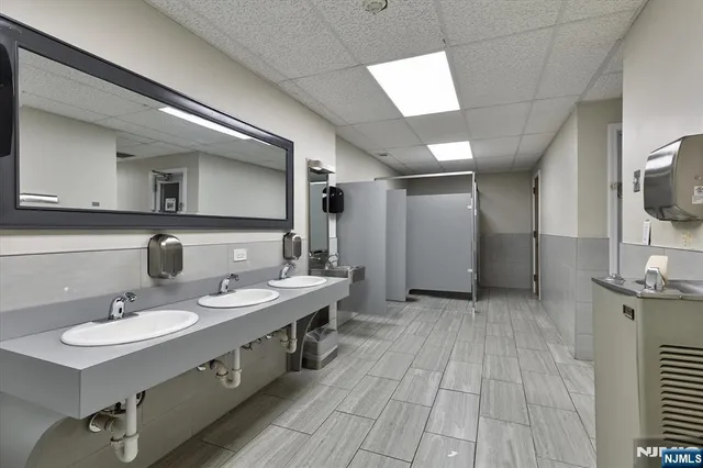 a spacious bathroom with a double vanity sink and a mirror