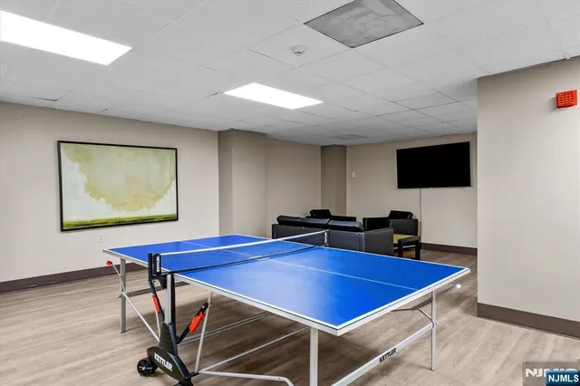 a view of a room with furniture and wooden floor