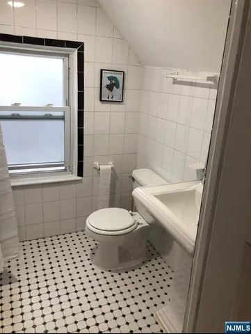 a white toilet sitting next to a window