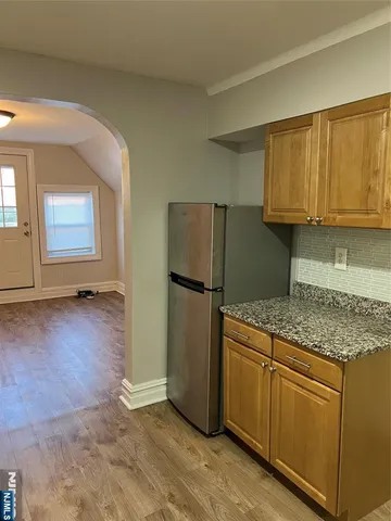 a kitchen with a refrigerator sink and cabinets