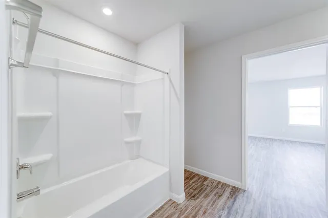 a bathroom with a bathtub and a shower