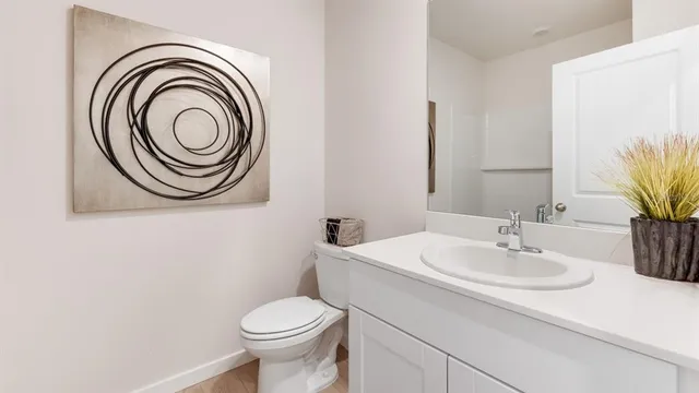 a bathroom with a sink a toilet and a mirror