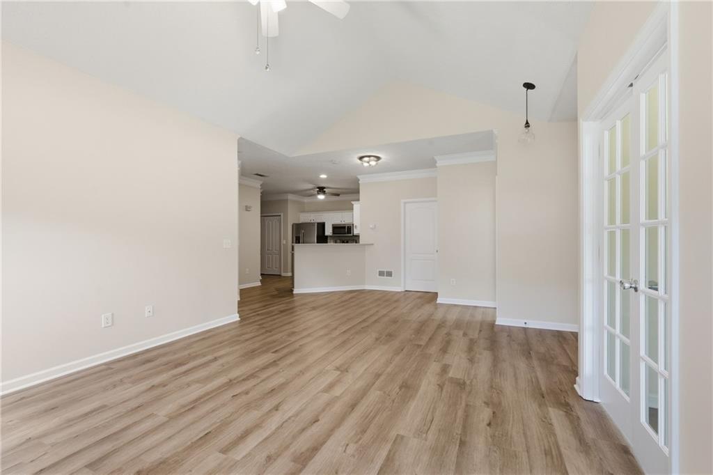 4533 Caleb Crossing, Unit 18 Powder Springs, GA 30127 - Photo 9 of 24 a view of empty room with wooden floor
