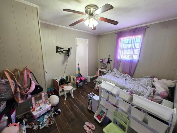 a bedroom with bed and a chandelier