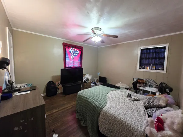 a bedroom with a bed and a chandelier