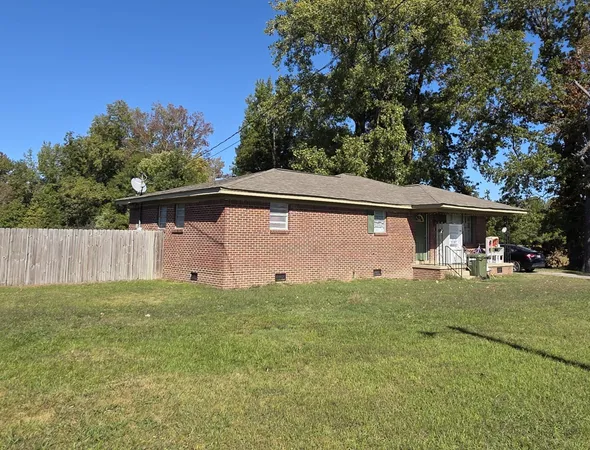 a front view of house with yard and trees